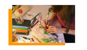 A woman drawing with pencils and pens